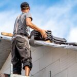 roofer on the roof of a family house, building a roof covering from ceramic tiles